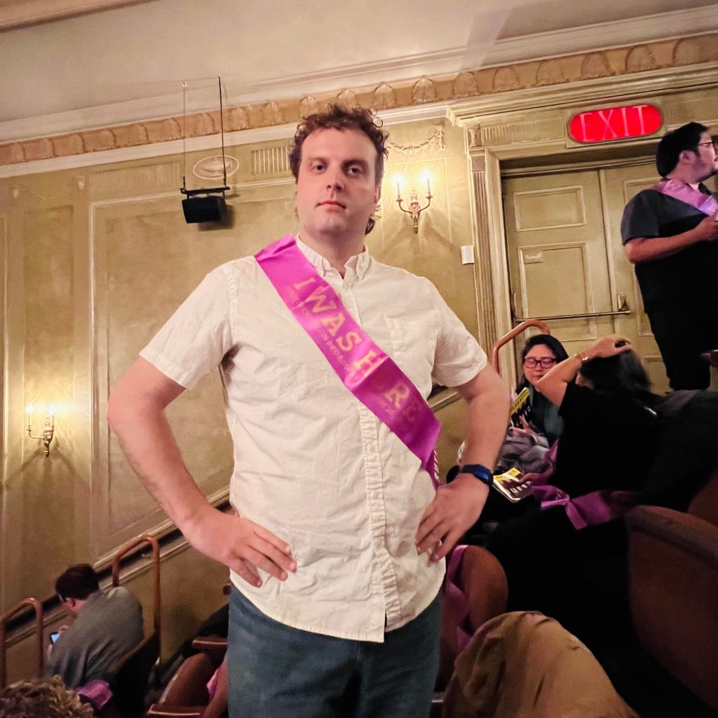 man standing at a theatre production