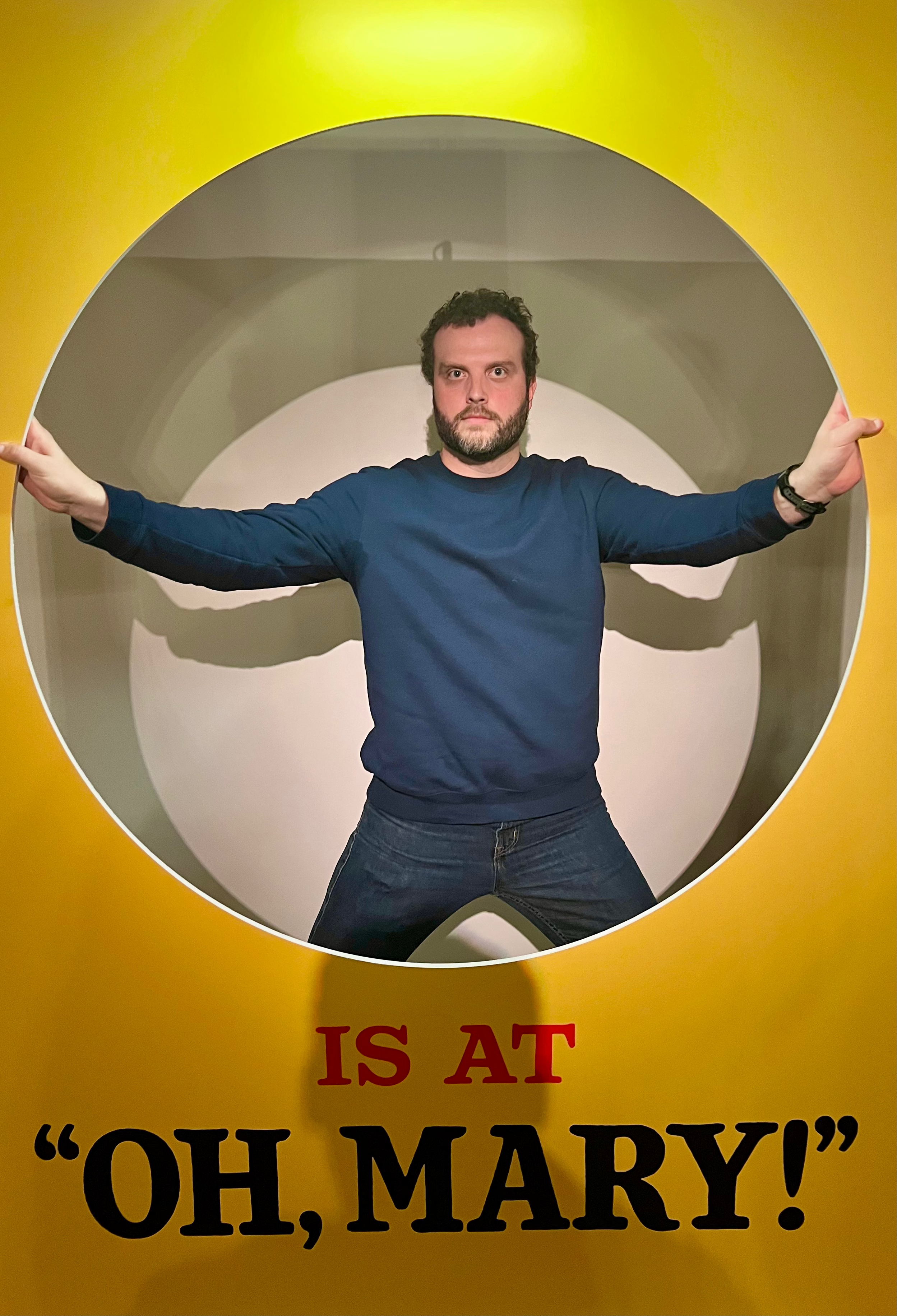 standing behind a photo booth option for Oh, Mary